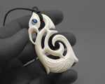 new zealand maori manaia pendant in hand