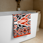 Maori Towel with a red, black, and white Kōwhaiwhai pattern draped over a bathtub.
