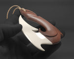 Hand-carved Hawaiian Makau wood fish hook necklace with a bone barb insert from Tuwharetoa Bone.