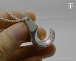 Detailed view of the sterling silver Lei Niho Palaoa pendant, a symbol of Hawaiian nobility