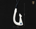 Hand carved Maori bone Hei Matau fish hook necklace on plain black background showing measurements