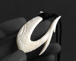 Side profile view of a masculine bone Hawaiian fish hook necklace, showing the thickness of the carved bone.