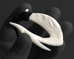 reverse angle of the carved bone Hawaiian Makau pendant, highlighting the smooth, high-polish artisan finish.