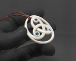 Maori Hei Koru necklace with three intertwined bone spirals on a brown cord, representing family and growth