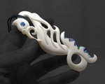 Maori Manaia bone pendant shown in hand