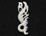 Maori Manaia bone pendant with a carved fish tail and triangular pieces of paua shell inlay