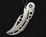A bone pendant featuring two Manaia figures