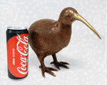 The Large Brass Kiwi shown next to a 330ml soda can to provide a clear real-world size comparison.