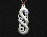 Detailed close-up of an intricately carved Maori Manaia bone pendant
