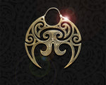 Intricate Moko Kauae design on a large circular brass earring by Tuwharetoa Bone