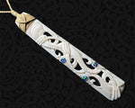 Hand-carved Maori bone toki pendant featuring a Manaia design
