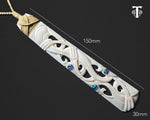 Close-up of the intricate Manaia carving on the bone toki pendant and measurements 