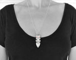 The Maori Taiaha pendant necklace on a model, showcasing its size and style