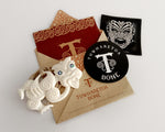 Maori bone Tiki pendant necklace presented in an envelope with stickers, ready for gifting.