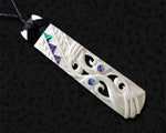 hand-carved Maori bone Hei Toki pendant with paua shell inlay and manaia design