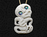 Front view of hand-carved Maori bone Tiki pendant necklace featuring a traditional design with intricate detailing and smooth bone finish